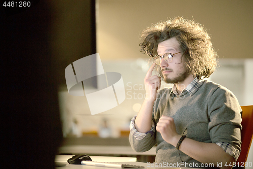 Image of businessman relaxing at the desk