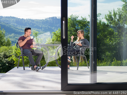 Image of couple enjoying morning coffee and breakfast