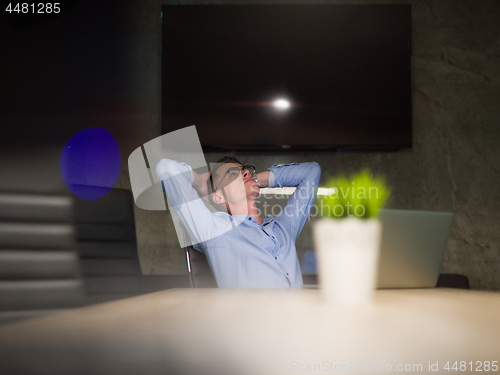 Image of businessman relaxing at the desk