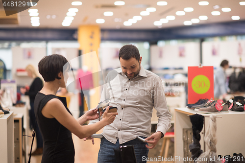 Image of couple chooses shoes At Shoe Store