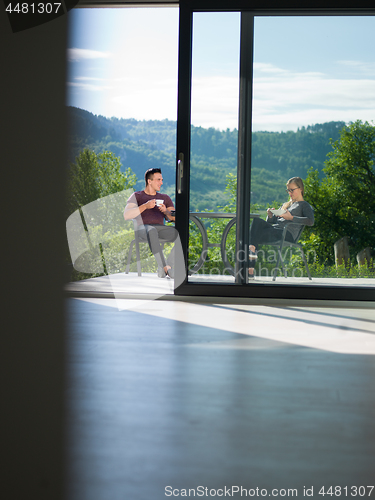 Image of couple enjoying morning coffee and breakfast