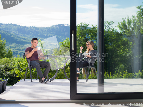 Image of couple enjoying morning coffee and breakfast