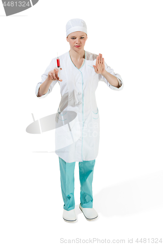 Image of beautiful young woman doctor in medical robe holding syringe in hand.