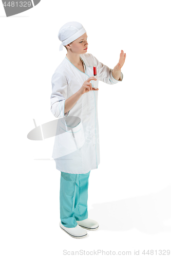 Image of beautiful young woman doctor in medical robe holding syringe in hand.