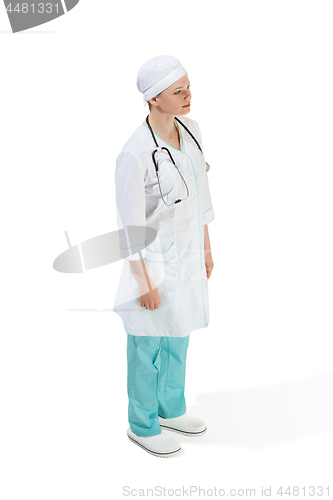 Image of Beautiful young woman in white coat posing and smiling at studio. Full length studio shot isolated on white.
