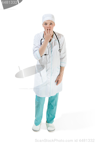 Image of Beautiful young woman is shoked in white coat posing at studio. Full length studio shot isolated on white.