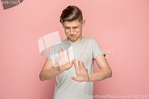 Image of Let me think. Doubtful pensive man with thoughtful expression making choice against pink background