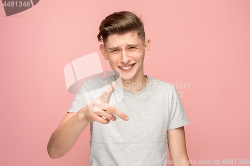 Image of The happy business man point you and want you, half length closeup portrait on pink background.