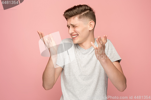 Image of Handsome man looking suprised isolated on pink
