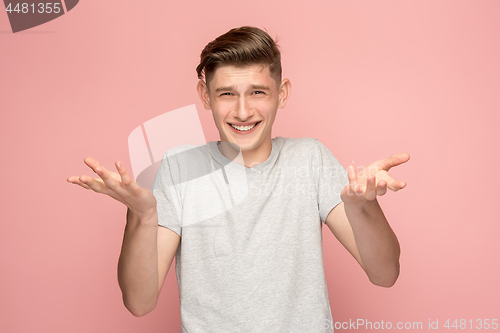 Image of Handsome man looking suprised isolated on pink
