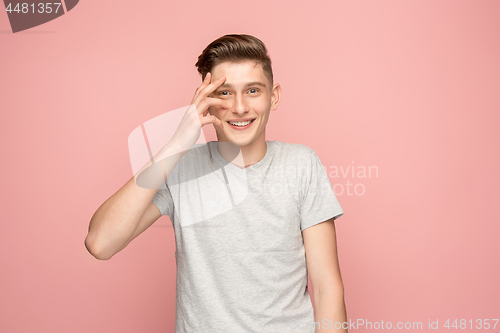 Image of Handsome man looking suprised isolated on pink
