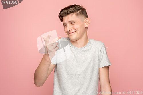Image of The happy business man standing and smiling against pink background.