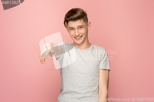 Image of The happy business man point you and want you, half length closeup portrait on pink background.