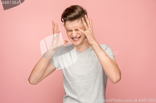 Image of Handsome man in stress isolated on pink