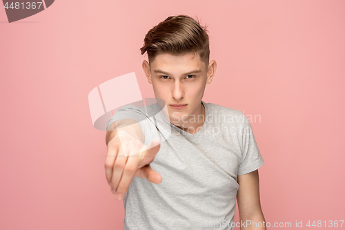 Image of The overbearing businessman point you and want you, half length closeup portrait on pink background.