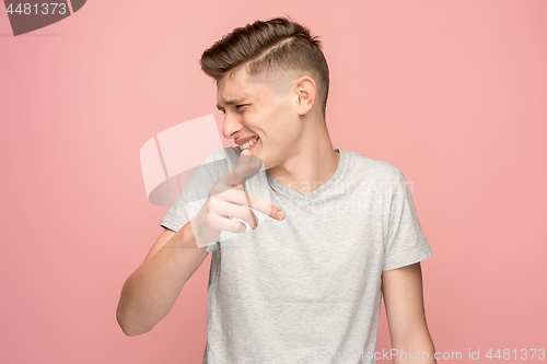 Image of The happy business man point you and want you, half length closeup portrait on pink background.