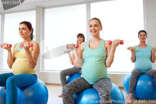 Image of pregnant women training with exercise balls in gym