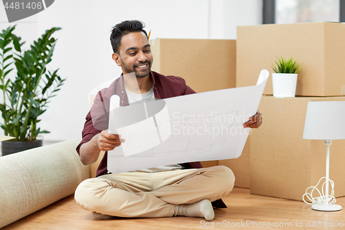 Image of man with boxes and blueprint moving to new home