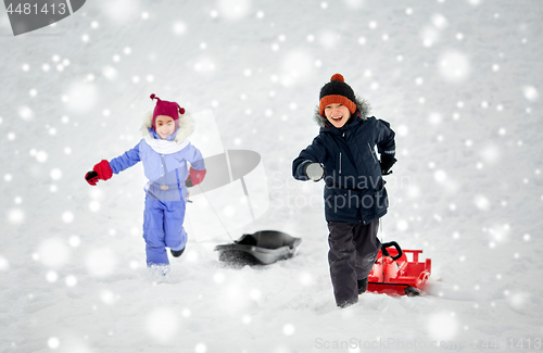 Image of happy kids with sled having fun outdoors in winter