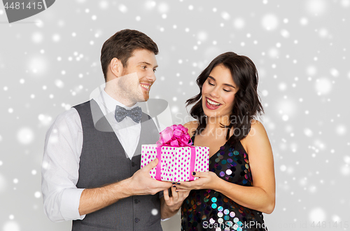 Image of happy couple with christmas gift