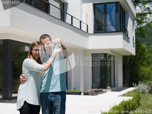 Image of couple hugging in front of  new luxury home