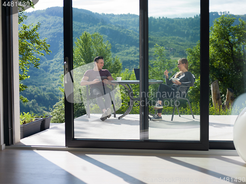 Image of couple enjoying morning coffee and breakfast