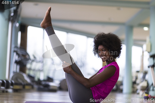 Image of african american woman exercise yoga in gym