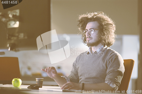 Image of Tired businessman working late