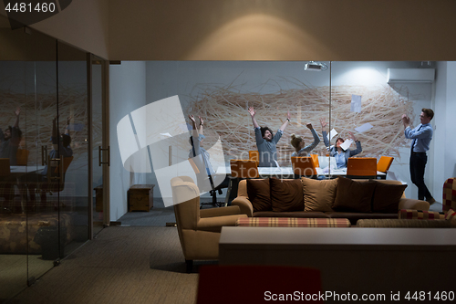 Image of Group of young business people throwing documents