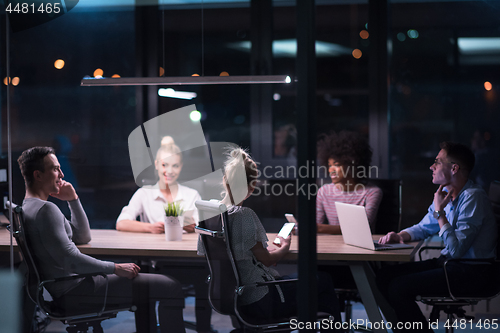 Image of Multiethnic startup business team in night office