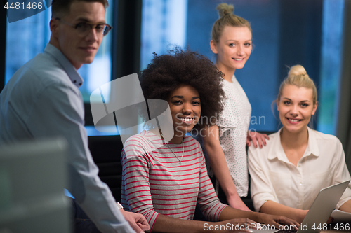 Image of Multiethnic startup business team in night office