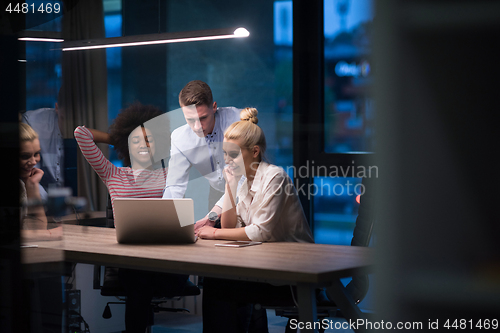 Image of Multiethnic startup business team in night office