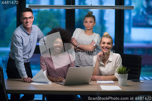 Image of Multiethnic startup business team in night office