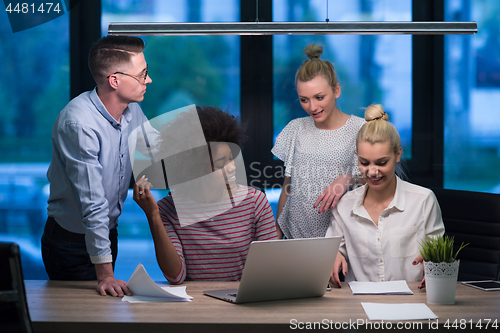 Image of Multiethnic startup business team in night office