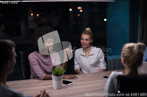 Image of Multiethnic startup business team in night office