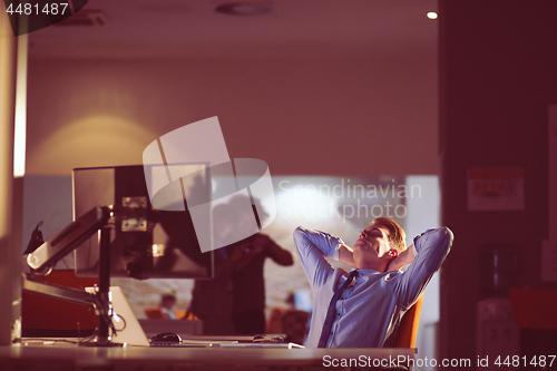 Image of businessman relaxing at the desk