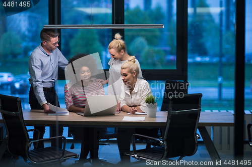 Image of Multiethnic startup business team in night office