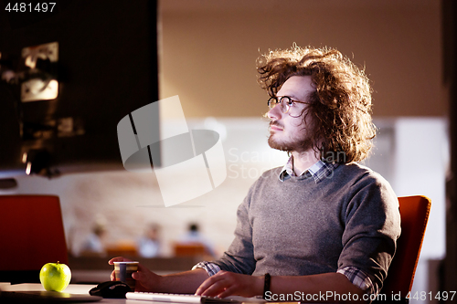 Image of Tired businessman working late