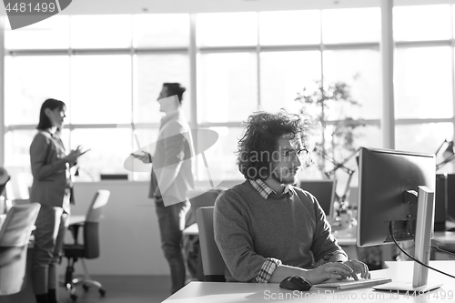 Image of businessman working using a computer in startup office