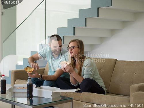 Image of couple eating pizza in their luxury home villa