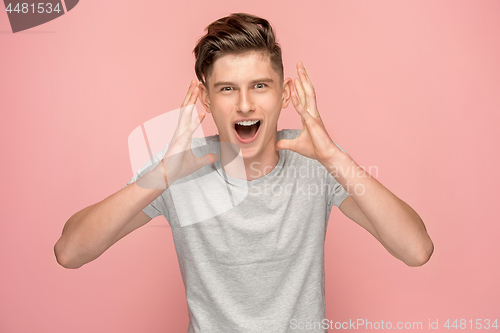 Image of Isolated on pink young casual man shouting at studio