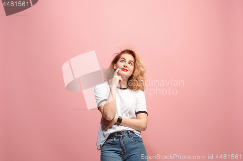 Image of Let me think. Doubtful pensive woman with thoughtful expression making choice against pink background