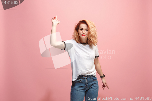 Image of Beautiful female half-length portrait isolated on pink studio backgroud. The young emotional surprised woman