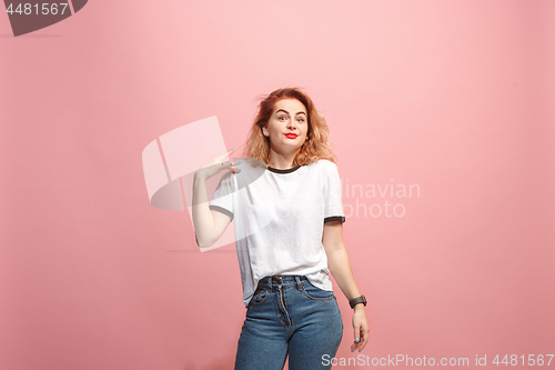 Image of Beautiful woman looking suprised isolated on pink