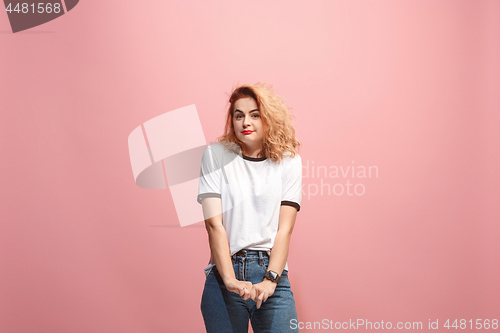 Image of Let me think. Doubtful pensive woman with thoughtful expression making choice against pink background