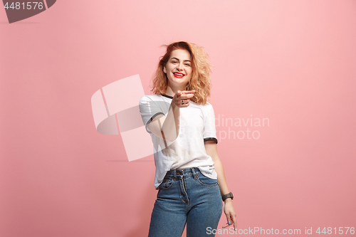 Image of The happy business woman point you and want you, half length closeup portrait on pink background.