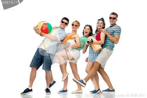 Image of happy friends with beach and summer accessories