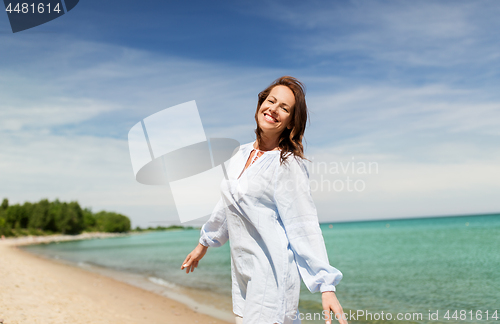 Image of happy smiling woman on summer beach