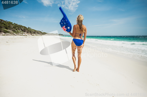 Image of Bikini woman with large pointing finger on the beach in Australi