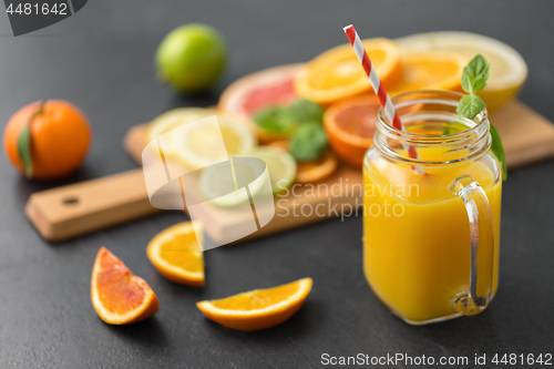 Image of mason jar glass of fruit juice on slate table top